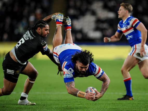 Wakefield's David Fifita is upended by Hull's Albert Kelly (PIC: Dean Williams)