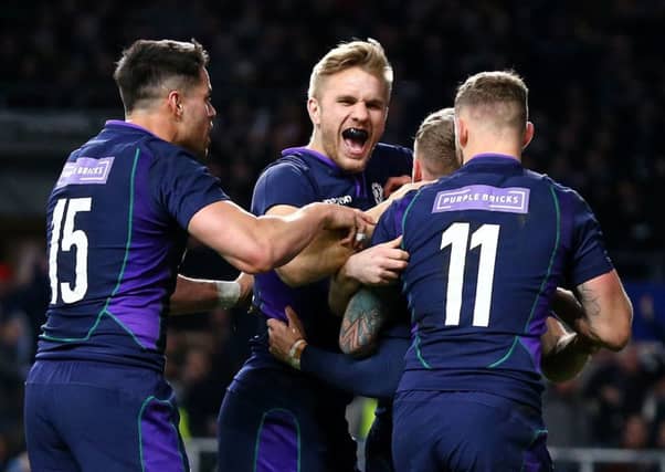 Scotland's Darcy Graham is mobbed by his team-mates after scoring his side's fourth try of the game during the Guinness Six Nations match at Twickenham Stadium, London. (Picture: Gareth Fuller/PA Wire)