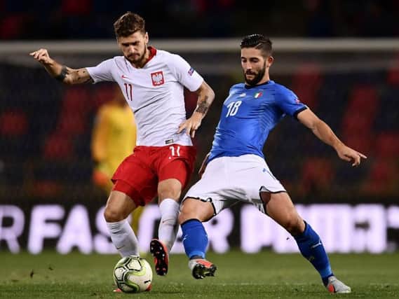 Leeds United midfielder Mateusz Klich in action for Poland against Italy.