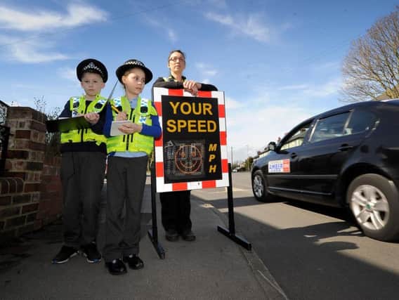 Children from Hawsworth Wood Primary School Hawksworth, Leeds, take part in a day of action with local Police..Connor Lake aged 9 and Bernice Bladon are pictured with PC Helen Brayshaw speed checking vehicles on the Hawksworth Estate..20th March 2019.Picture by Simon Hulme