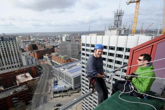 Ben White gets ready to abseil down the CVL building in Leeds earlier today.