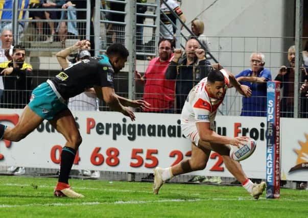 CATCH ME IF YOU CAN: Catalans' Fouad Yaha goes over in the corner against Leeds Rhinos. Picture: Laurent Selles/RLphotos.com