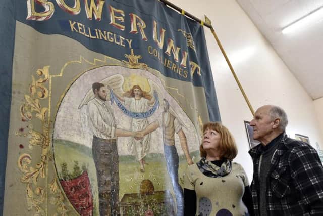Helen Pratt , community curator at Temple Newsam House and former Primrose Hill  miner Ron Taylor with an original banner to be used in an exhibition. It was too delicate to take outside. Picture: Steve Riding.