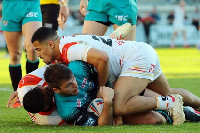 FLOORED: Leeds Rhinos' Tom Briscoe sees his access blocked by Catalans Dragons. Picture: RLPhotos.com