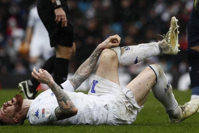 Pontus Jansson goes down injured during Leeds United's 1-0 defeat to Sheffield United.