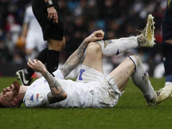 Pontus Jansson goes down injured during Leeds United's 1-0 defeat to Sheffield United.