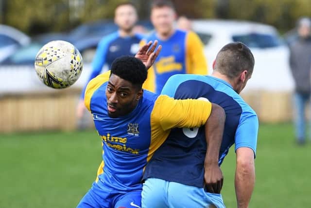 Hope Inn's T'Nique Fishley tangles with Luke Burns of HT Sports duing Sunday's Sanford Cup semi-final. PIC: Jonathan Gawthorpe