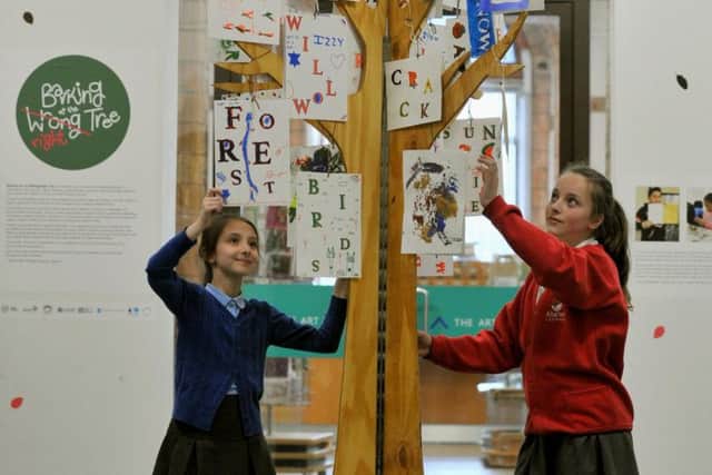 Yasmin Dikei 9 from  from Thorpe Primary School   and Maisie Syke 11 from Allerton C of E Primary School  by the  centrepiece to the exhibition the Barking up the Right Tree.