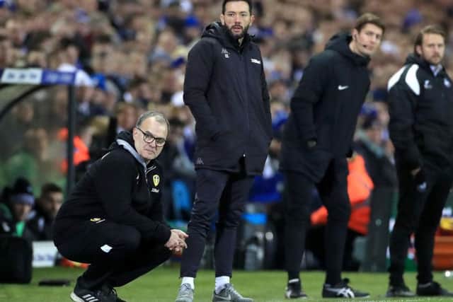 Carlos Corberan, centre, on the touchline with Marcelo Bielsa during Leeds United's win over Swansea City in February.