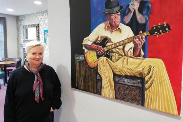 Amanda Rosevare with one of her paintings