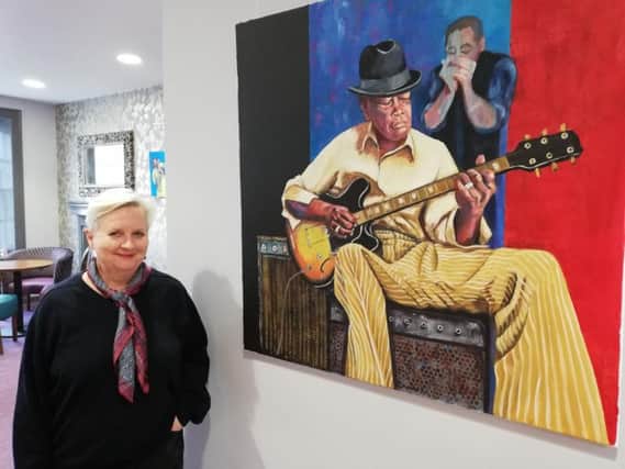 Amanda Rosevare with one of her paintings