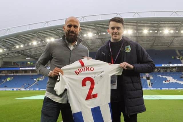 Ellis Lee with Brighton and Hove Albion captain Bruno
