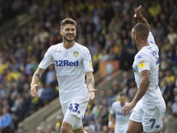 Leeds United midfielder Mateusz Klich celebrates with Kemar Roofe.