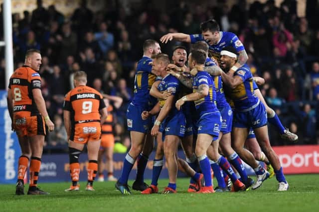 Brad Dwyer is mobbed by his team-mates after his golden point drop goal against Castleford.
Picture: Jonathan Gawthorpe.