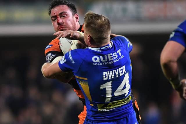 Grant Millington is tackled by Rhinos Brad Dwyer.
Picture: Jonathan Gawthorpe.