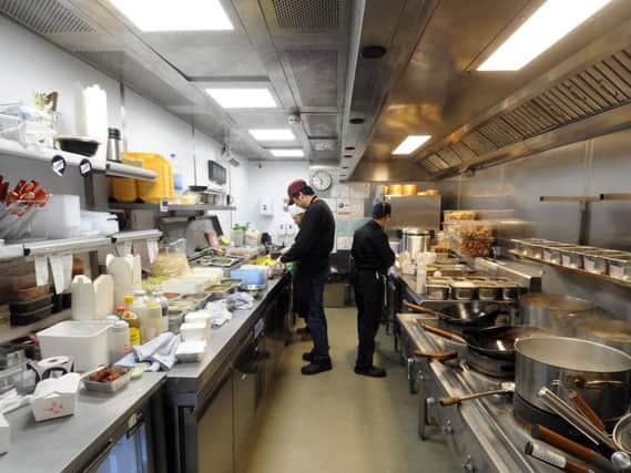 Chefs at work in one of the kitchen units at the Deliveroo Editions site in Leeds.