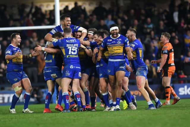 Leeds Rhinos' Brad Dwyer is mobbed by his team-mates after his golden point drop goal against Castleford.