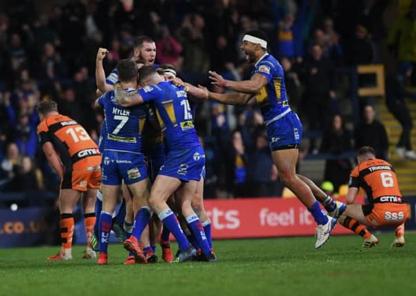 Brad Dwyer is mobbed by his tea- mates after his golden point drop goal against Castleford.