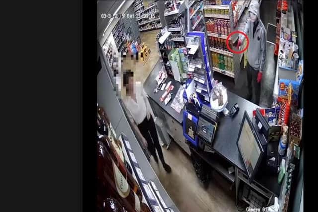 The woman bravely escorted the robber out of the shop