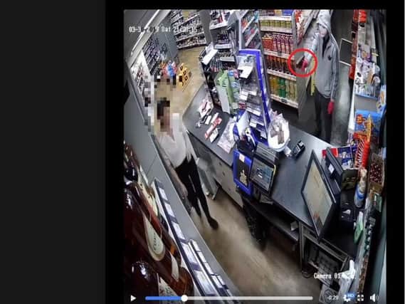 The woman bravely escorted the robber out of the shop