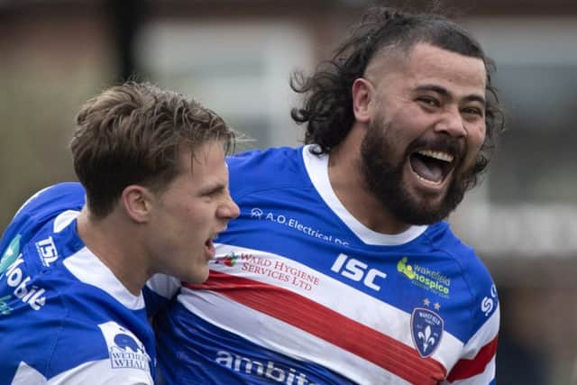 David Fifita celebrates the opening try of the match with Wakefield team-mate Jacob Miller. PIC: James Hardisty