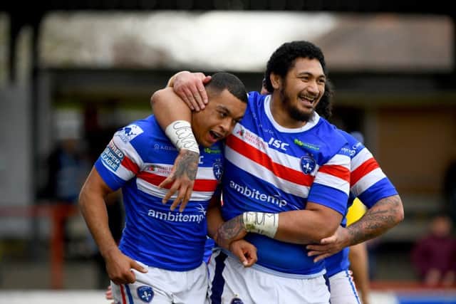 Try scorer Reece Lyne celebrates with Wakefield team-mate Pauli Pauli. PIC: James Hardisty