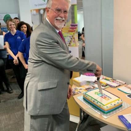 CAKE: Chairman Chris Eatwell cuts into a cake to celebrate the launch of West Yorkshire CANN( children with additional needs).