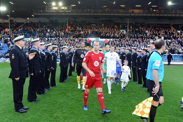 Sailors from HMS Ark Royal give Leeds United and Bristol City's players a guard of honour in 2010.
