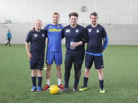 Leeds United captain Liam Cooper with members of the disability team.