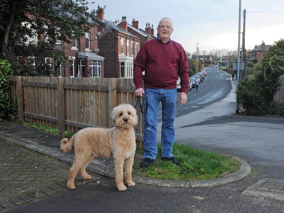 Tam Fulton at home in Beeston with his dog George.