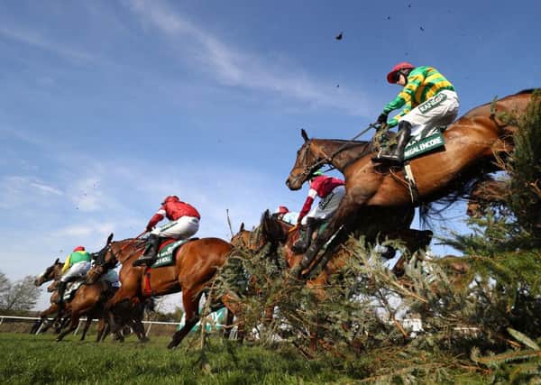 Jonathan Burke and Regal Encore follow Davy Russell on Grand National hero Tiger Roll at the Canal Turn.