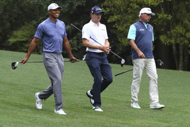 Tiger Woods, Justin Thomas and Fred Couples, from left, walk down the 11th fairway at Augusta. Picture: Curtis Compton/AP