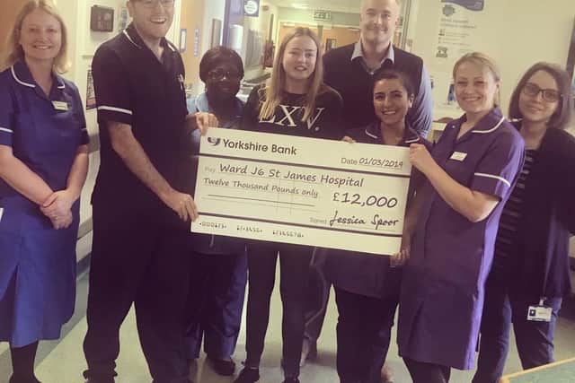 Jessica Spoor (centre) presenting a cheque for 12,000 to ward J6 at St James's Hospital in Leeds.