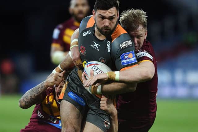 Castleford's Matt Cook is tackled by Huddersfield's Alex Mellor and Aaron Murphy. Picture: Jonathan Gawthorpe.