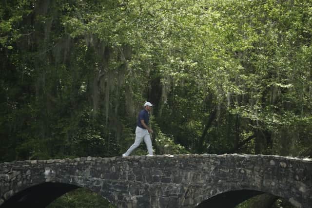 Crossing the bridge to success?: Tiger Woods goes over the Nelson Bridge on the 13th hole.