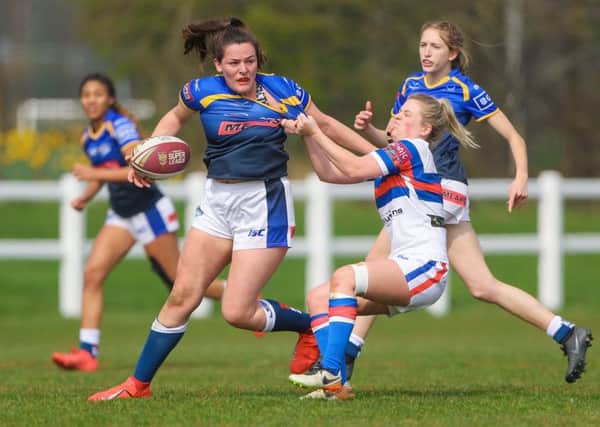 Leeds Rhinos' Amy Johnson is tackled by Wakefield's Caitlin Clifton.