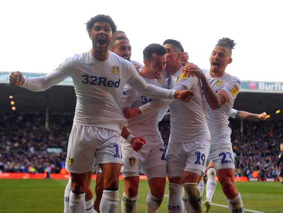 Leeds United's Jack Harrison, centre, is mobbed by his team-mates after scoring the winning goal. Picture by Tony Johnson.