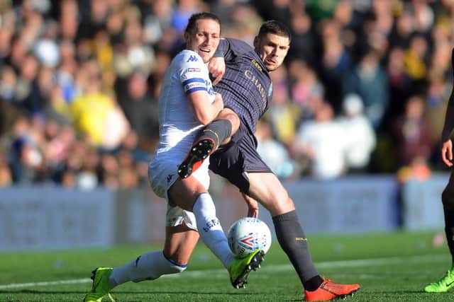 Luke Ayling challenges Sheffield Wednesday's Gary Hooper.