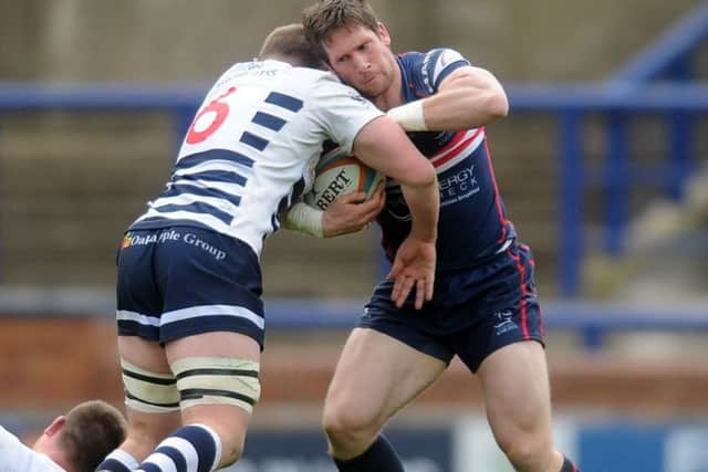 Pitched battle: Lewis Wilson of Yorkshire Carnegie tackles Doncaster Knights Mat Clark (Picture: Tony Johnson)