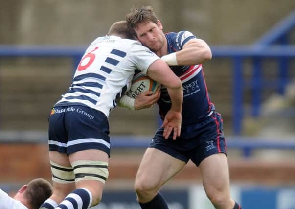 Pitched battle: Lewis Wilson of Yorkshire Carnegie tackles Doncaster Knights Mat Clark (Picture: Tony Johnson)