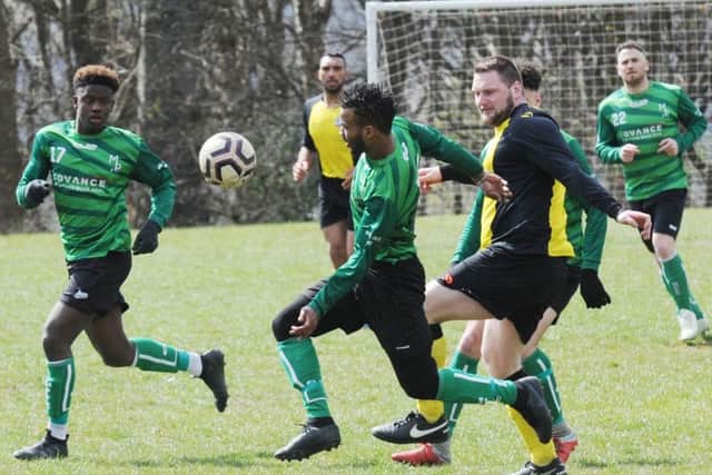 Armando Andrada, of Middleton Park, is first to the ball at Division 4 rivals North Leeds Reserves. PIC: Steve Riding