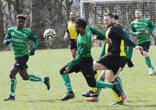 Armando Andrada, of Middleton Park, is first to the ball at Division 4 rivals North Leeds Reserves. PIC: Steve Riding