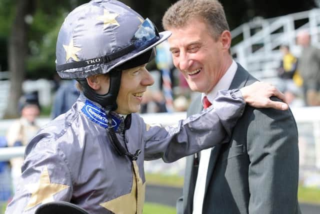 Trainer Kevin Ryan sharing a joke with jockey Jamie Spencer. PIC: Anna Gowthorpe/PA Wire