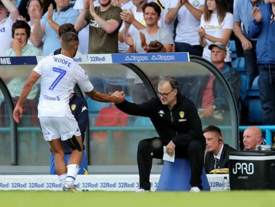 PUT IT THERE: Kemar Roofe and Marcelo Bielsa.
