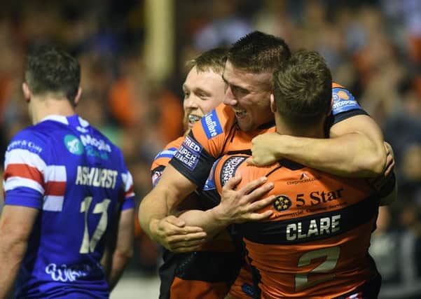 Castleford's Greg Minikin celebrates his try with Cory Aston and James Clare.
