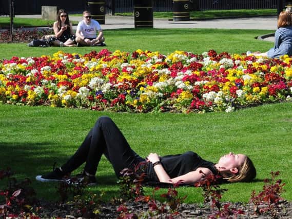 People enjoy the warm weather in Park Square, Leeds..20th April 2019.Picture by Simon Hulme