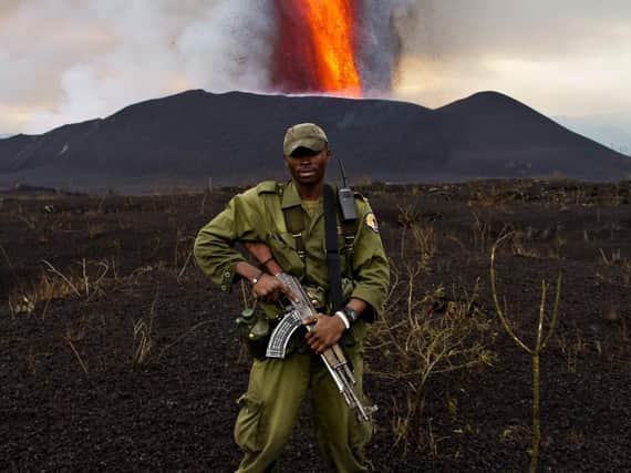 An armed ranger at Virunga National Park during the eruption of the Mount Nyamulagira volcano in 2011