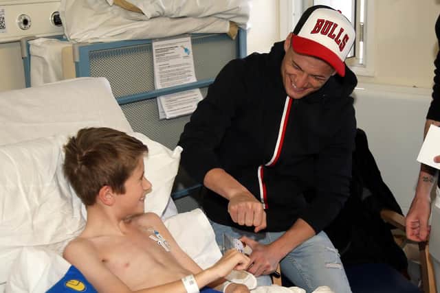 Leeds United's Gjanni Alioski meets a young patient at Leeds Children's Hospital.