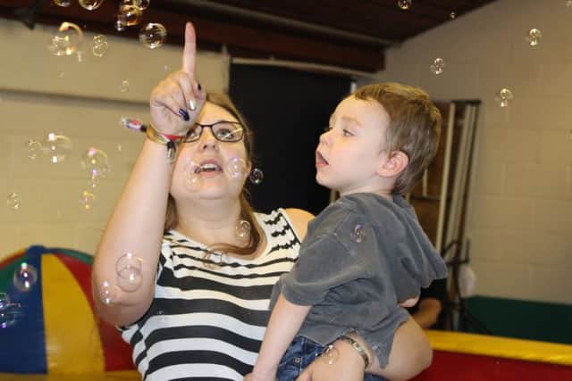 FUN TIME: Parent trustee Lora Bedford pops bubbles with her son, Phoenix, at a SNAPS event.