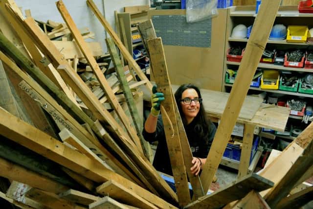 Charlotte Stanley Manager at Leeds Wood Recycling  sorting out some wood at their premesis in Leeds.